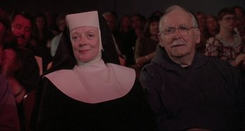Movie still from “Sister Act 2: Back in the Habit” (1993), directed by Bill Duke – An old man and a woman dressed as nuns; Medium shot, Low angle