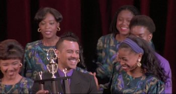 Movie still from “Sister Act 2: Back in the Habit” (1993), directed by Bill Duke – A group of people standing next to each other holding a trophy; Close Up shot, Low angle