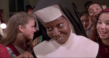 Movie still from “Sister Act 2: Back in the Habit” (1993), directed by Bill Duke – A woman dressed as a nun smiling for the camera; Close Up shot, Low angle