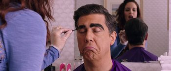 Movie still from “Sisters” (2015), directed by Jason Moore – A man is getting his eyebrows done by a makeup artist; Close Up shot, Over the shoulder angle