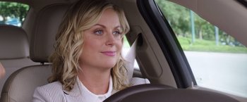 Movie still from “Sisters” (2015), directed by Jason Moore – A woman sitting in the driver's seat of a car; Close Up shot, Over the shoulder angle