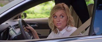 Movie still from “Sisters” (2015), directed by Jason Moore – A woman sitting in the driver's seat of a car; Close Up shot, Over the shoulder angle