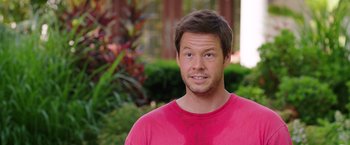 Movie still from “Sisters” (2015), directed by Jason Moore – A person wearing a red shirt; Close Up shot, Over the shoulder angle