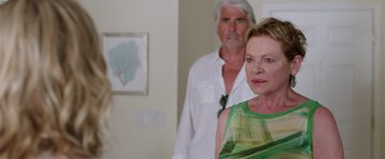 Movie still from “Sisters” (2015), directed by Jason Moore – An older man and a younger woman standing in a room; Close Up shot, Over the shoulder angle