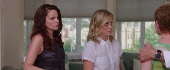 Movie still from “Sisters” (2015), directed by Jason Moore – Two women standing next to each other in front of a window; Close Up shot, Over the shoulder angle