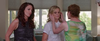 Movie still from “Sisters” (2015), directed by Jason Moore – Three women standing in front of each other; Medium shot, Over the shoulder angle
