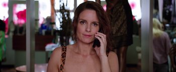 Movie still from “Sisters” (2015), directed by Jason Moore – A woman is talking on a cell phone; Close Up shot, Over the shoulder angle