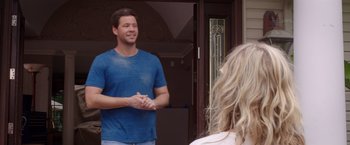 Movie still from “Sisters” (2015), directed by Jason Moore – A man standing next to a woman in front of a building; Medium shot, Over the shoulder angle