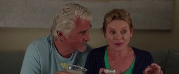 Movie still from “Sisters” (2015), directed by Jason Moore – An older man and a younger woman sitting next to each other; Close Up shot, Over the shoulder angle