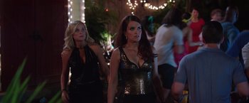 Movie still from “Sisters” (2015), directed by Jason Moore – Two beautiful women standing next to each other; Medium shot, Over the shoulder angle