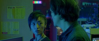 A woman and a man standing next to each other in a room