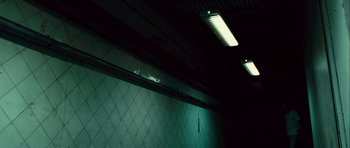 Movie still from “Sleep Tight” (2011), directed by Jaume Balagueró – A dark room with lights on the ceiling and walls; Wide shot, Low angle