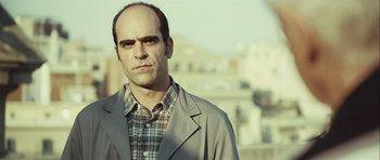 Movie still from “Sleep Tight” (2011), directed by Jaume Balagueró – A man in a plaid shirt and a gray jacket; Close Up shot, Low angle