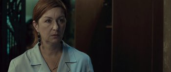 Movie still from “Sleep Tight” (2011), directed by Jaume Balagueró – A person wearing a white shirt; Close Up shot, Over the shoulder angle