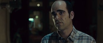 Movie still from “Sleep Tight” (2011), directed by Jaume Balagueró – A man in a plaid shirt is looking to his left; Close Up shot, Over the shoulder angle