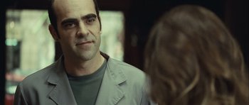 Movie still from “Sleep Tight” (2011), directed by Jaume Balagueró – A person wearing a jacket; Close Up shot, Over the shoulder angle