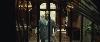 Movie still from “Sleep Tight” (2011), directed by Jaume Balagueró – A man standing in front of an open door; Wide shot, Low angle