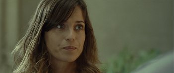 Movie still from “Sleep Tight” (2011), directed by Jaume Balagueró – A woman's face with long brown hair; Close Up shot, Over the shoulder angle