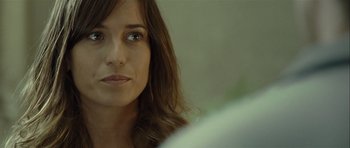 Movie still from “Sleep Tight” (2011), directed by Jaume Balagueró – A woman's face with long brown hair; Close Up shot, Over the shoulder angle