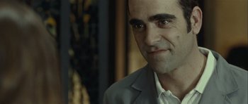 Movie still from “Sleep Tight” (2011), directed by Jaume Balagueró – A person wearing a suit and tie; Close Up shot, Over the shoulder angle