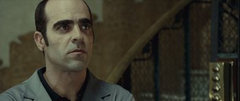 Movie still from “Sleep Tight” (2011), directed by Jaume Balagueró – A person wearing a suit and tie; Close Up shot, Low angle