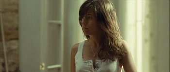 Movie still from “Sleep Tight” (2011), directed by Jaume Balagueró – A woman in a white shirt is looking to her left; Close Up shot, Low angle