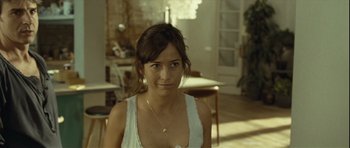 Movie still from “Sleep Tight” (2011), directed by Jaume Balagueró – A young woman wearing a white shirt and a necklace; Close Up shot, Over the shoulder angle