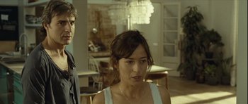 Movie still from “Sleep Tight” (2011), directed by Jaume Balagueró – A man and a woman standing in front of a chandelier; Close Up shot, Over the shoulder angle