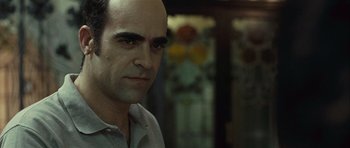 Movie still from “Sleep Tight” (2011), directed by Jaume Balagueró – A person wearing a white shirt; Close Up shot, Over the shoulder angle