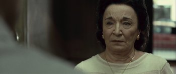 Movie still from “Sleep Tight” (2011), directed by Jaume Balagueró – An older woman is looking at the camera; Close Up shot, Over the shoulder angle