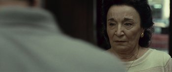 Movie still from “Sleep Tight” (2011), directed by Jaume Balagueró – An older woman looking at herself in the mirror; Close Up shot, Over the shoulder angle