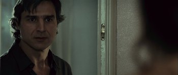 Movie still from “Sleep Tight” (2011), directed by Jaume Balagueró – A man standing in front of a door; Close Up shot, Over the shoulder angle