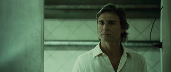 Movie still from “Sleep Tight” (2011), directed by Jaume Balagueró – A person wearing a white shirt; Close Up shot, Low angle