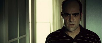 Movie still from “Sleep Tight” (2011), directed by Jaume Balagueró – A person wearing a striped shirt; Close Up shot, Low angle