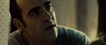 Movie still from “Sleep Tight” (2011), directed by Jaume Balagueró – A man's face in a dark room; Close Up shot, Low angle