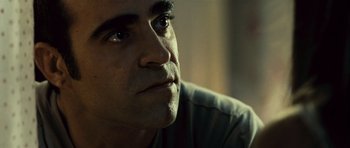 Movie still from “Sleep Tight” (2011), directed by Jaume Balagueró – A man's face looking upward; Close Up shot, Low angle