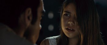 Movie still from “Sleep Tight” (2011), directed by Jaume Balagueró – A young woman is looking at a man in the dark; Close Up shot, Over the shoulder angle
