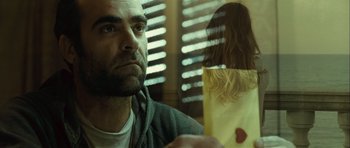 Movie still from “Sleep Tight” (2011), directed by Jaume Balagueró – A man sitting in front of a window with a woman; Close Up shot, Low angle