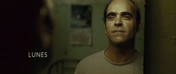 Movie still from “Sleep Tight” (2011), directed by Jaume Balagueró – A person wearing a white t - shirt; Close Up shot, Over the shoulder angle