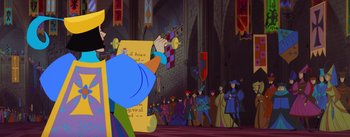 Movie still from “Sleeping Beauty” (1959), directed by Wolfgang Reitherman – A crowd of people are gathered in a large room; Medium shot, Over the shoulder angle