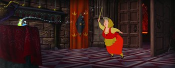 Movie still from “Sleeping Beauty” (1959), directed by Wolfgang Reitherman – A woman in a red and yellow dress holding a wand; Wide shot, High angle