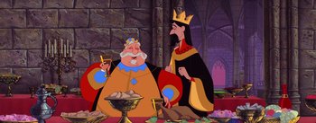 Movie still from “Sleeping Beauty” (1959), directed by Wolfgang Reitherman – A king and queen are standing next to each other in front of a stone wall; Medium shot, Over the shoulder angle