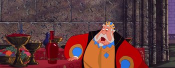 Movie still from “Sleeping Beauty” (1959), directed by Wolfgang Reitherman – A cartoon of a king sitting on a couch; Medium shot, Overhead angle