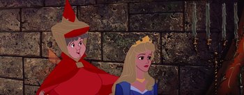 Movie still from “Sleeping Beauty” (1959), directed by Wolfgang Reitherman – A woman in a blue dress and a man in a red suit are next to a brick wall; Medium shot, Over the shoulder angle