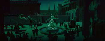 Movie still from “Sleeping Beauty” (1959), directed by Wolfgang Reitherman – A fountain in the middle of a courtyard at night; Extreme Wide shot, High angle