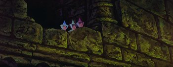 Movie still from “Sleeping Beauty” (1959), directed by Wolfgang Reitherman – A group of people standing on top of a stone wall; Wide shot, Low angle