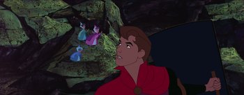 Movie still from “Sleeping Beauty” (1959), directed by Wolfgang Reitherman – A man in a red robe looking up at a group of fairies; Medium shot, Over the shoulder angle
