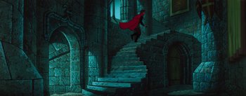 Movie still from “Sleeping Beauty” (1959), directed by Wolfgang Reitherman – A man with a red cape walking down a set of stairs; Extreme Wide shot, High angle