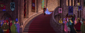 Movie still from “Sleeping Beauty” (1959), directed by Wolfgang Reitherman – A man and a woman walking down a red staircase; Extreme Wide shot, High angle