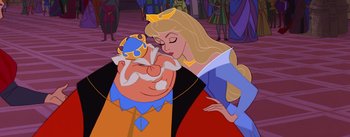 Movie still from “Sleeping Beauty” (1959), directed by Wolfgang Reitherman – A man and a woman kissing each other in front of a crowd of onlookers; Close Up shot, High angle